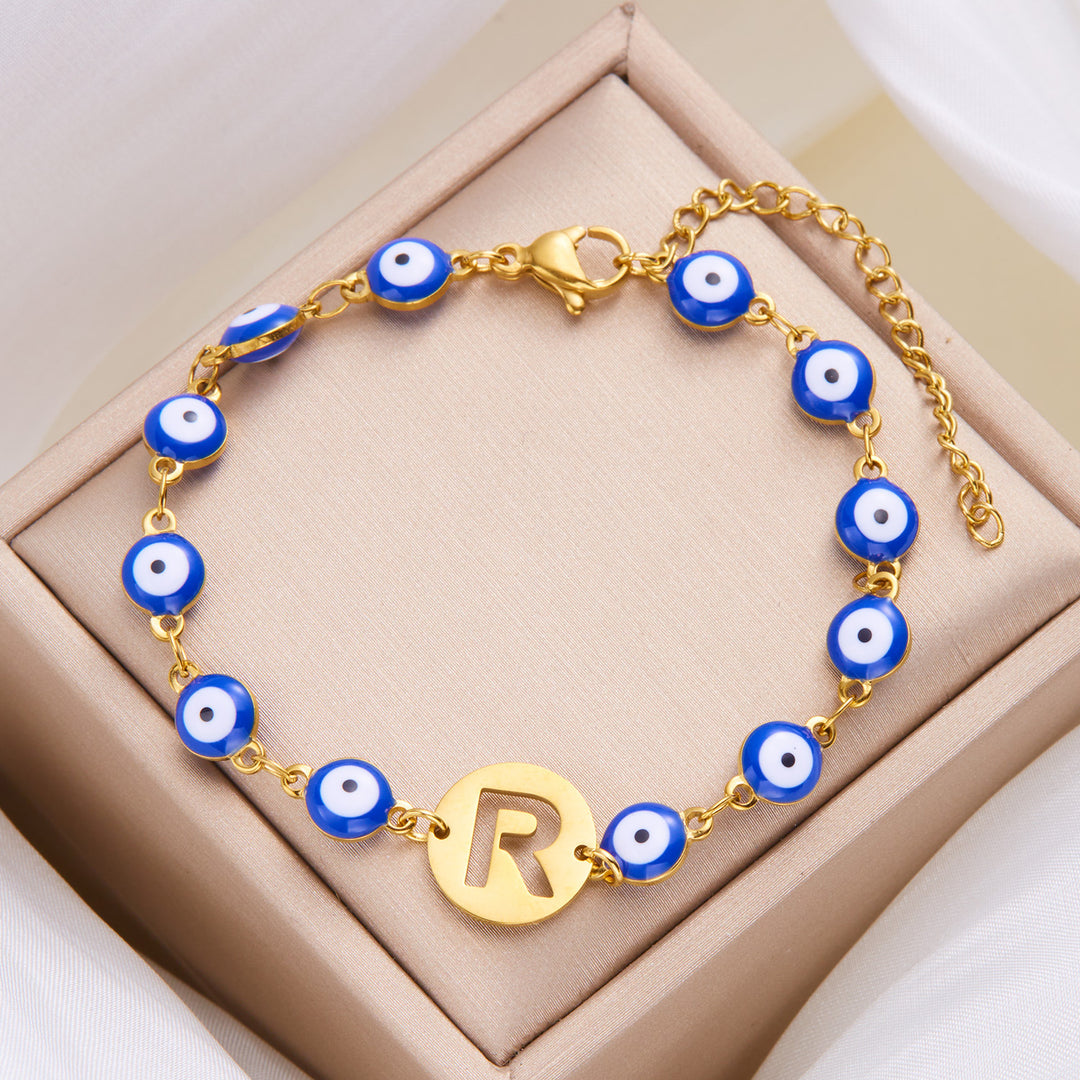 Women's High-grade Stainless Steel Blue Eyes Fashion Hollowed-out 26 Letter Bracelet