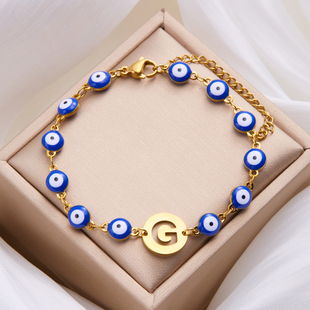 Women's High-grade Stainless Steel Blue Eyes Fashion Hollowed-out 26 Letter Bracelet