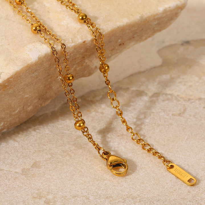 Exquisito collar de oro de 18 km joyas de acero electroplacado joyas de acero impermeable para la cadena de doble capa.